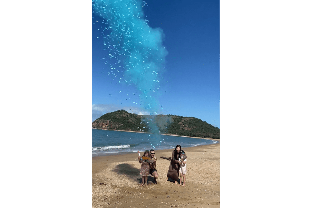 biodegradable blue confetti and holi powder gender reveal on the beach blue boy